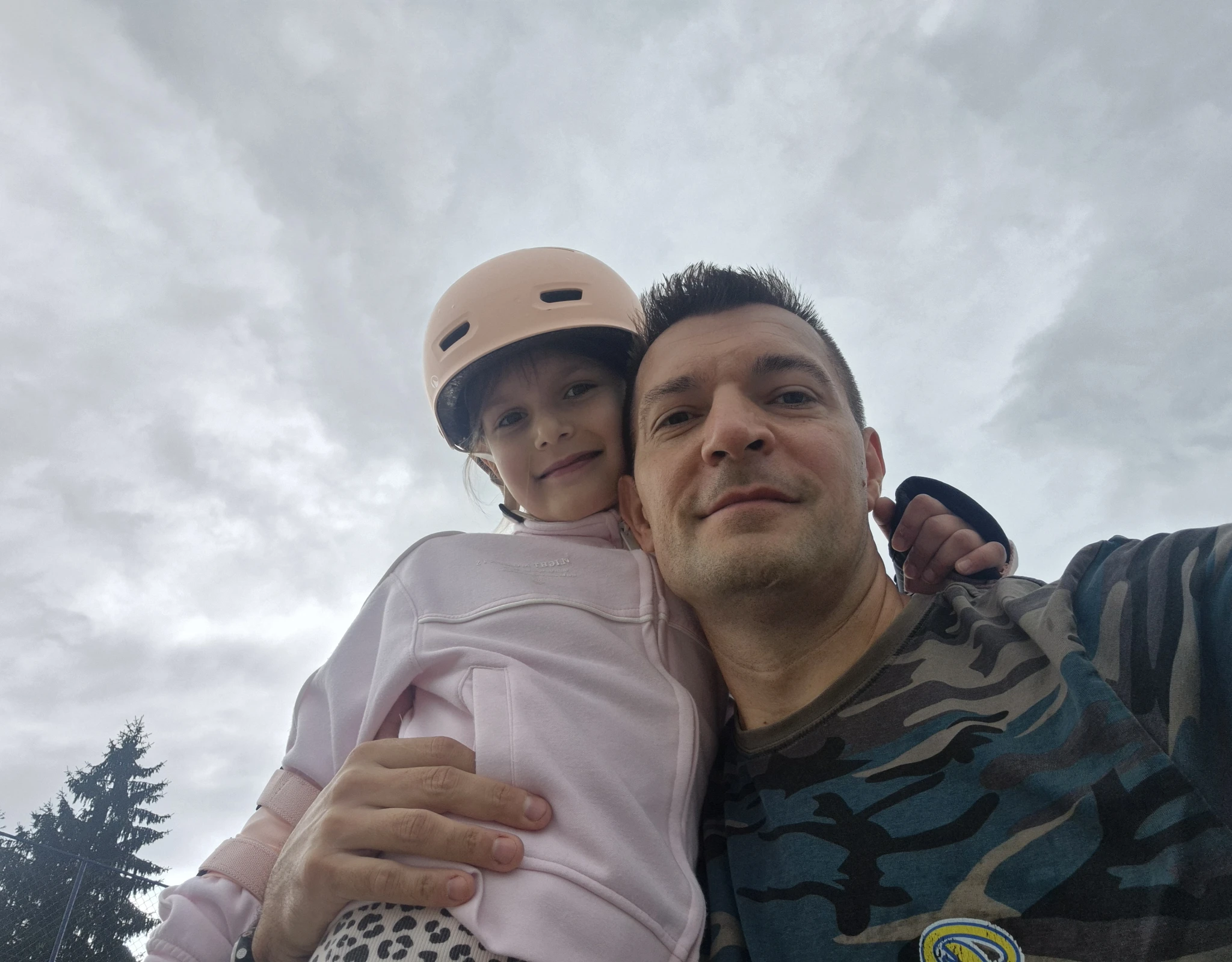 Otac i kći na igralištu tijekom zajedničkoga poslijepodneva prije kiše