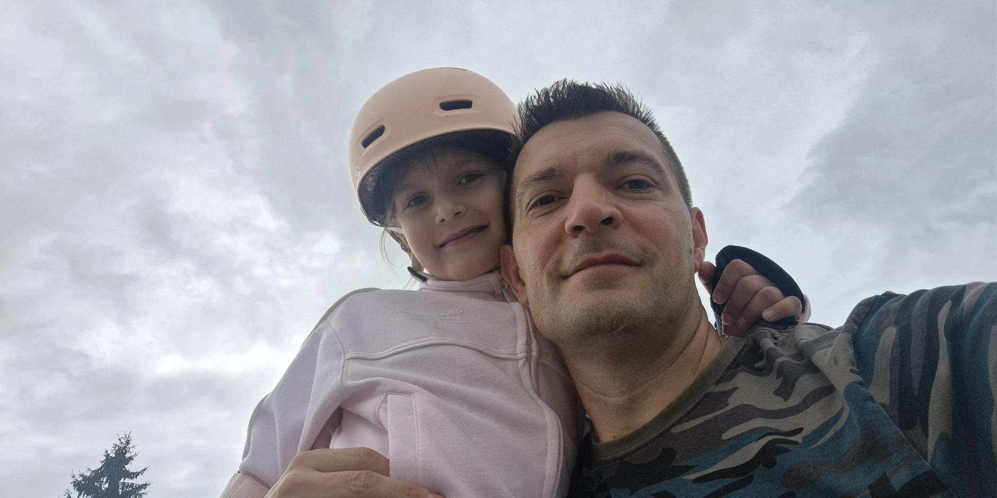 Otac i kći na igralištu tijekom zajedničkoga poslijepodneva prije kiše